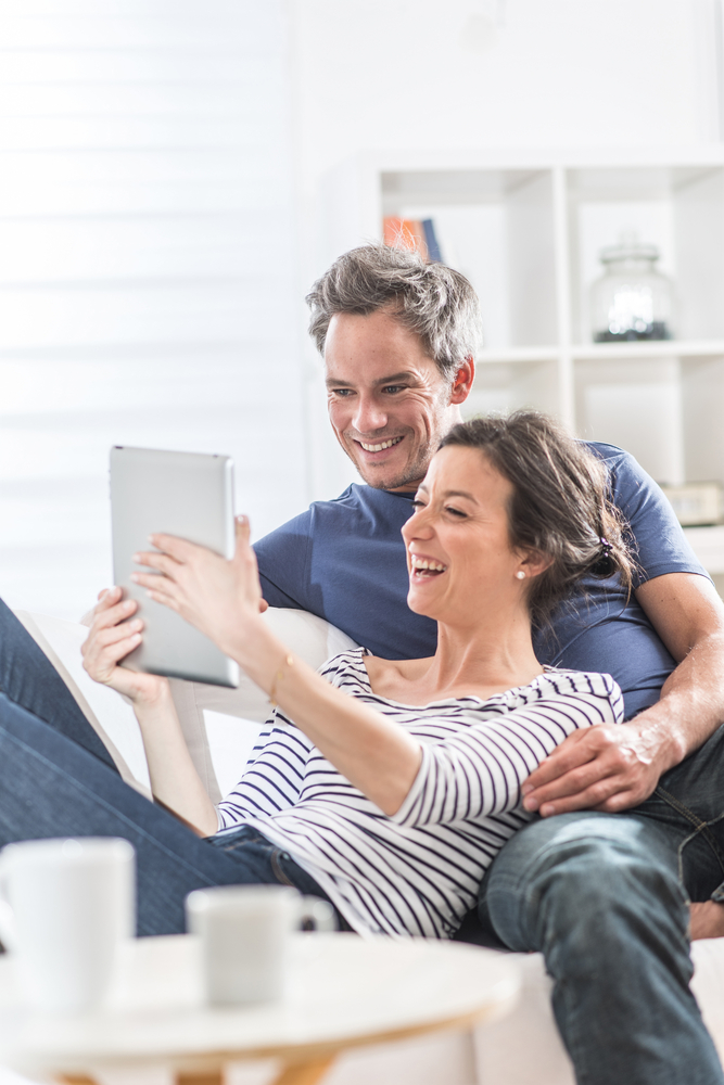 A,Nice,Couple,At,Home,Using,A,Tablet,,They,Are